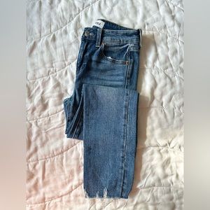 Dark blue midrise pistola denim jeans.